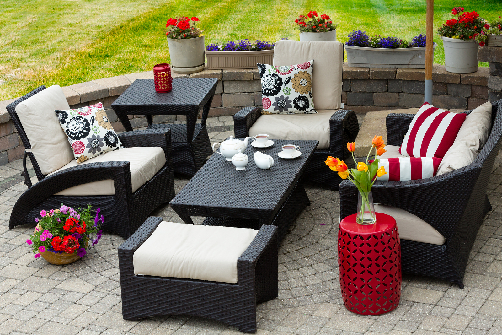 backyard patio decorated with red white and black furniture and flowers